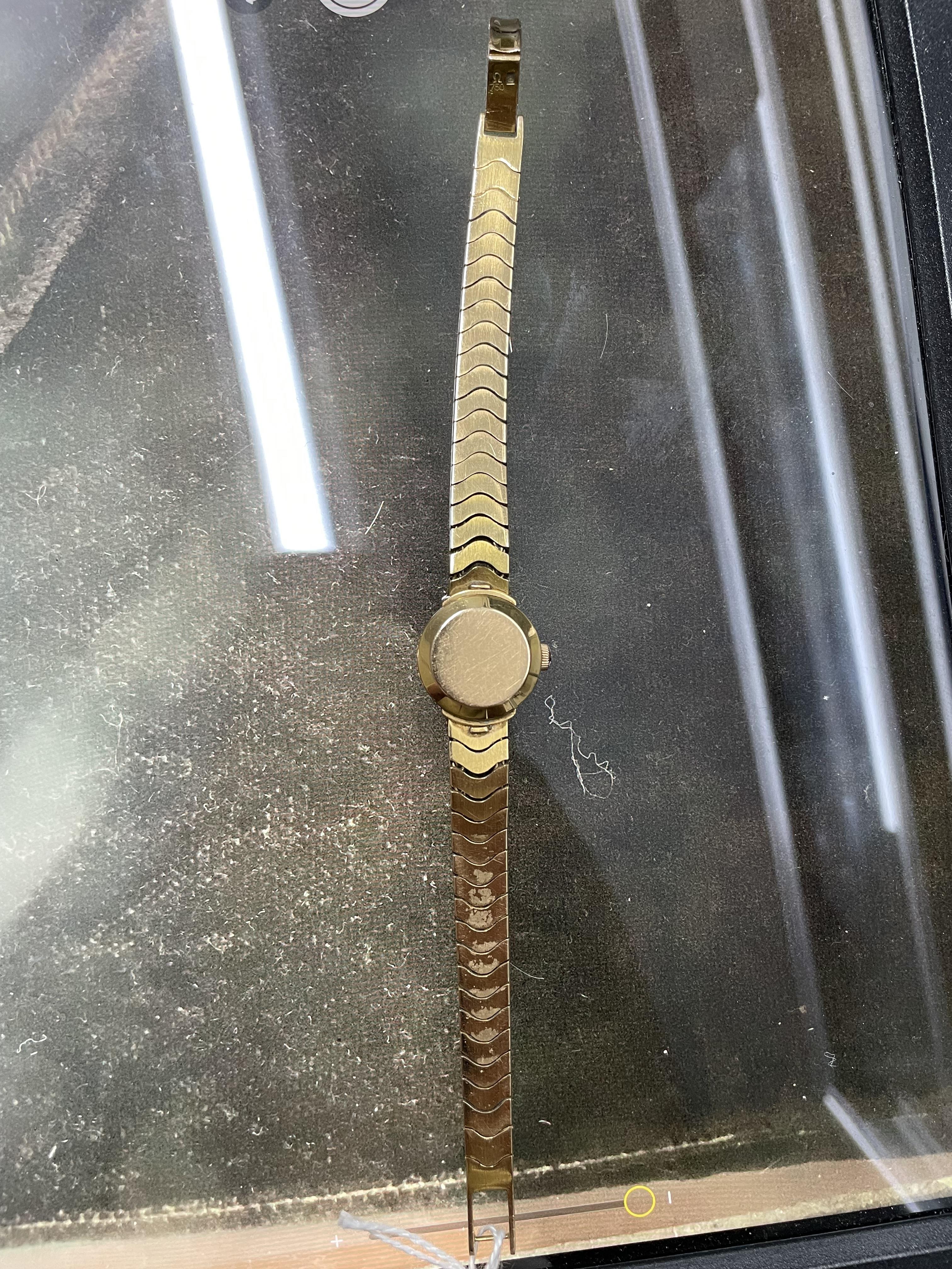 A lady's yellow metal, stamped 750, Omega Ladymatic wrist watch, on a 750 bracelet, length 17.cm, gross weight 38.9 grams.